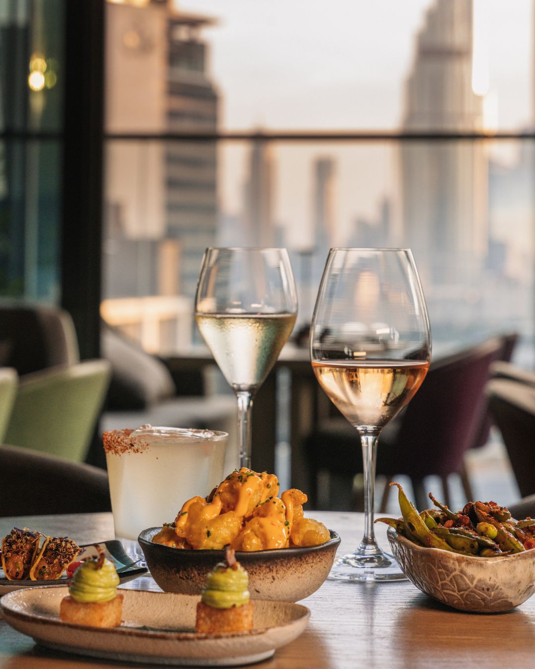 Dining table with food and drinks at CLAP Dubai Golden Hours